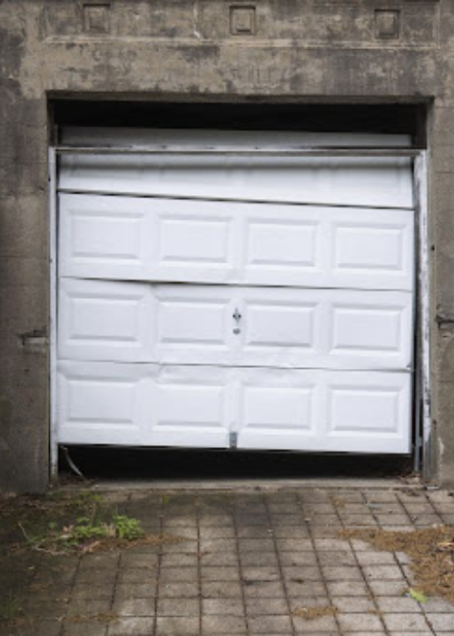 Comparing a broken garage door spring with a new replacement.