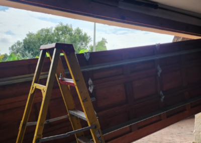 Durable steel sectional door being fitted for a local business. - Bedfordview Garage Door Repairs | Your Garage Door Guy Durable steel sectional door being fitted for a local business.