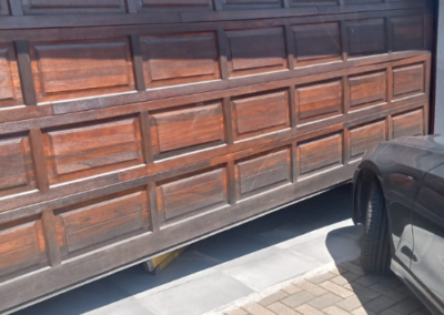 Broken garage door spring being removed by a technician. - Bedfordview Garage Door Repairs | Your Garage Door Guy Broken garage door spring being removed by a technician.